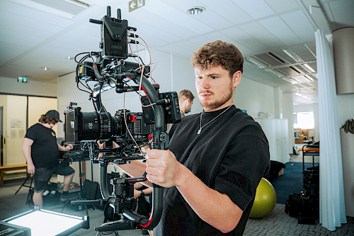 Kameraman připravující kameru k natáčení